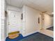 Hallway featuring the unit door with a decorative wreath and an elevator nearby at 100 Bluff View Dr # 317A, Belleair Bluffs, FL 33770