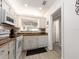 Compact kitchen with white cabinets, appliances, and a window above the sink for added light at 100 Bluff View Dr # 317A, Belleair Bluffs, FL 33770