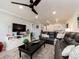 Spacious living room featuring a plush sectional sofa and ceiling fan at 100 Bluff View Dr # 317A, Belleair Bluffs, FL 33770