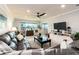 Spacious living room featuring a large leather sofa, work space, and bright windows at 100 Bluff View Dr # 317A, Belleair Bluffs, FL 33770