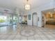 Welcoming lobby entrance with tile flooring, elevator access, a seating area, and automatic doors at 100 Bluff View Dr # 317A, Belleair Bluffs, FL 33770