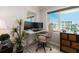 Bright workspace with a modern desk, ergonomic chair, and natural light from the window at 100 Bluff View Dr # 317A, Belleair Bluffs, FL 33770