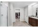 Bright bathroom with shower, walk-in closet, tile floors, vanity with granite countertop, and access to toilet at 10105 Paradise Fish Dr, Riverview, FL 33578