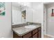 Bright bathroom features a granite countertop vanity and large mirror at 10105 Paradise Fish Dr, Riverview, FL 33578