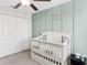 Light and airy Bedroom with a white crib and plenty of natural light at 10105 Paradise Fish Dr, Riverview, FL 33578