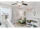 Cozy Bedroom with a white crib, changing table, and whimsical decorations at 10105 Paradise Fish Dr, Riverview, FL 33578