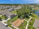 Aerial view of a Gathering-friendly community, showcasing a playground, walking path, and a tranquil lake at 10105 Paradise Fish Dr, Riverview, FL 33578