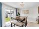 Bright dining room features a modern chandelier and sliding glass doors to the backyard at 10105 Paradise Fish Dr, Riverview, FL 33578