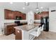 Modern kitchen featuring granite counters, stainless appliances, dark wood cabinetry, and bar stool seating at 10105 Paradise Fish Dr, Riverview, FL 33578