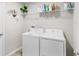 This laundry room comes equipped with white washer and dryer units at 10105 Paradise Fish Dr, Riverview, FL 33578
