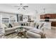 Bright, spacious living area with a large sectional, tile floors, flowing seamlessly into the dining and kitchen areas at 10105 Paradise Fish Dr, Riverview, FL 33578