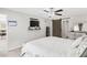 Spacious main bedroom boasts a ceiling fan, floating shelves with TV, and sliding barn door to bathroom at 10105 Paradise Fish Dr, Riverview, FL 33578
