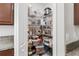 Organized walk-in pantry featuring wire shelving and clear storage containers for optimal space and storage at 10105 Paradise Fish Dr, Riverview, FL 33578