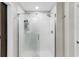 Bathroom shower featuring a glass door, tile surround, and overhead showerhead at 10105 Paradise Fish Dr, Riverview, FL 33578