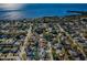 Expansive aerial shot offering panoramic views of the neighborhood, ocean, and surrounding lush greenery at 1017 Jamaica Way, Tarpon Springs, FL 34689