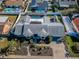 Aerial view of a home showcasing a screened pool, fenced yard, complemented by mature trees and landscaping at 1017 Jamaica Way, Tarpon Springs, FL 34689