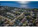 Stunning aerial view showcases the neighborhood, with sparkling water views, verdant trees and clear blue skies at 1017 Jamaica Way, Tarpon Springs, FL 34689