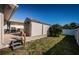 A shed and backyard with a grill, creating an ideal setting for storage and outdoor dining at 1017 Jamaica Way, Tarpon Springs, FL 34689