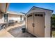 A well-equipped backyard featuring a shed, grill, table, and chairs for outdoor enjoyment at 1017 Jamaica Way, Tarpon Springs, FL 34689