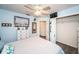 Bedroom with white dresser and ensuite bathroom at 1017 Jamaica Way, Tarpon Springs, FL 34689