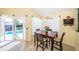 Sunny breakfast nook with tile flooring and sliding glass doors offering a view of the sparkling pool at 1017 Jamaica Way, Tarpon Springs, FL 34689