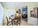 Cozy dining area featuring a wooden table, black chairs, and lots of natural light at 1017 Jamaica Way, Tarpon Springs, FL 34689