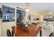 Open dining area with a wooden table and chairs that connects to the kitchen and living room at 1017 Jamaica Way, Tarpon Springs, FL 34689