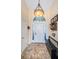 Inviting foyer with neutral walls, tiled floor, arched window, and decorative bench, creating a warm welcome at 1017 Jamaica Way, Tarpon Springs, FL 34689