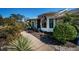 Charming home featuring lush landscaping and a welcoming walkway to the front door, accented by an American flag at 1017 Jamaica Way, Tarpon Springs, FL 34689