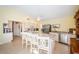 Well-lit kitchen featuring a large island with seating, granite countertops, and modern appliances at 1017 Jamaica Way, Tarpon Springs, FL 34689