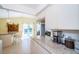 Bright kitchen featuring granite countertops, white cabinetry, and bar seating overlooking a pool at 1017 Jamaica Way, Tarpon Springs, FL 34689