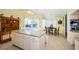 Eat-in kitchen with island and seating, dining area, and sliding glass doors to outdoor space at 1017 Jamaica Way, Tarpon Springs, FL 34689