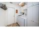 Bright laundry room featuring white cabinets, modern appliances, and convenient access to the exterior at 1017 Jamaica Way, Tarpon Springs, FL 34689