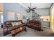 Living room featuring vaulted ceilings, shelving and two comfortable brown leather couches at 1017 Jamaica Way, Tarpon Springs, FL 34689