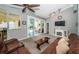 Open-concept living room showcasing indoor/outdoor living with sliding glass doors to the screened lanai and pool area at 1017 Jamaica Way, Tarpon Springs, FL 34689
