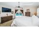 Large main bedroom with vaulted ceiling, TV, and sliding door to the pool area at 1017 Jamaica Way, Tarpon Springs, FL 34689