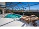 A pool area with lounge chairs by the pool, offering a relaxing backyard retreat at 1017 Jamaica Way, Tarpon Springs, FL 34689