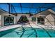 Beautiful pool with a screened-in enclosure, offering privacy and protection from the elements at 1017 Jamaica Way, Tarpon Springs, FL 34689