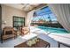 Stylish screened patio featuring a refreshing pool, comfortable seating, and serene backyard views at 1017 Jamaica Way, Tarpon Springs, FL 34689