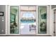 A view of the pool and lanai through sliding glass doors, offering indoor/outdoor living and entertainment at 1017 Jamaica Way, Tarpon Springs, FL 34689