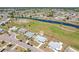 Overhead real estate shot showing a manicured green neighborhood with water views, and long driveway at 1021 Augusta Dr, Sun City Center, FL 33573