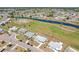 Real estate aerial view of neighborhood showing landscaping, water views, and an extended driveway at 1021 Augusta Dr, Sun City Center, FL 33573