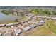 High angle aerial view of Sun City Center homes beside a lake with community recreation center nearby at 1021 Augusta Dr, Sun City Center, FL 33573