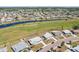 Scenic aerial shot of the neighborhood with a canal, green spaces, and a house with a long driveway at 1021 Augusta Dr, Sun City Center, FL 33573