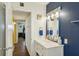 Bathroom features a vanity with plenty of lighting and storage space with blue accent wall at 1021 Augusta Dr, Sun City Center, FL 33573