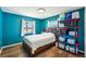 Bedroom features hardwood floors, a large bed, and a large window for plenty of light at 1021 Augusta Dr, Sun City Center, FL 33573