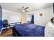 Bedroom features hardwood floors, ceiling fan, a large bed, and a closet space at 1021 Augusta Dr, Sun City Center, FL 33573