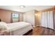 Comfortable bedroom with wood floors, a window offering natural light, and neutral colored walls at 1021 Augusta Dr, Sun City Center, FL 33573