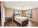 Cozy bedroom with wood floors, two windows offering ample natural light, and neutral colored walls at 1021 Augusta Dr, Sun City Center, FL 33573