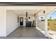 Covered carport featuring a concrete floor, access door, and partial fencing, providing sheltered parking at 1021 Augusta Dr, Sun City Center, FL 33573